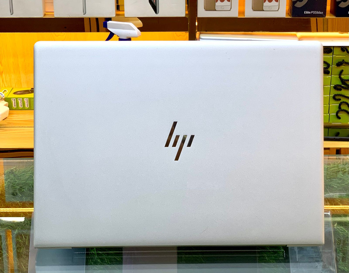 HP EliteBook closed back view showing white aluminum chassis with HP logo