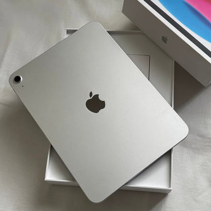 Apple iPad 10th Generation Silver back view on original box with colorful iPad box in background