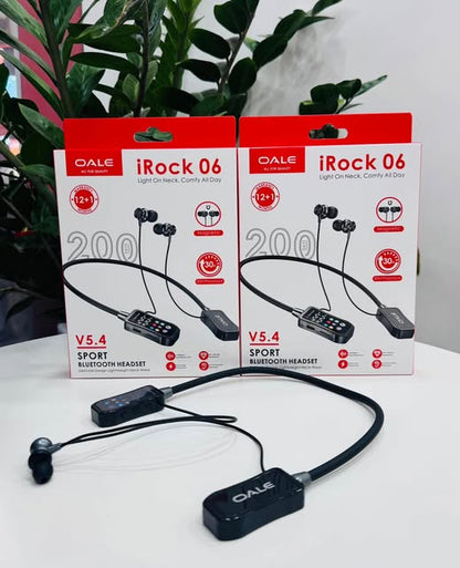 OALE iRock 06 neckband headset unboxed black device with two original boxes behind on white surface with green plants in background