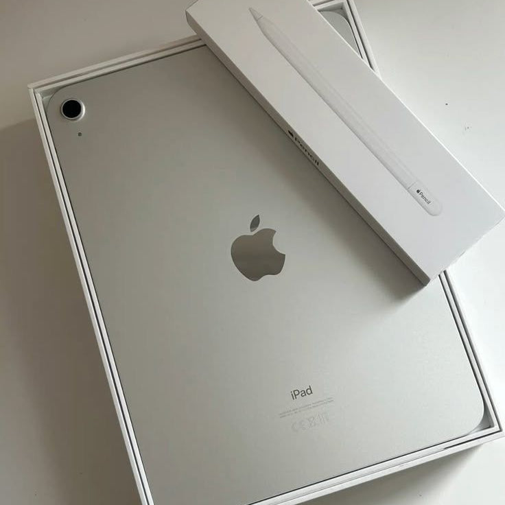 Apple iPad Silver back view in original box with Apple Pencil box on white surface