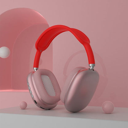 P9 Pro Max wireless headphones pink and red colorway studio shot on pink background with decorative spheres