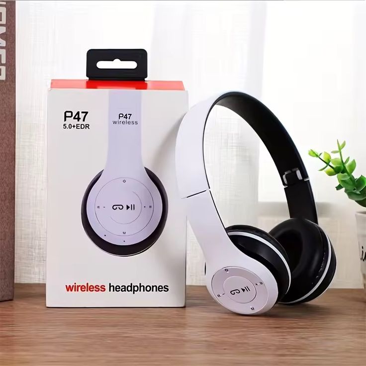 P47 wireless Bluetooth headphones white and black color with original white box on wooden surface with plant in background