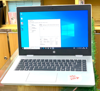 HP EliteBook open showing AMD Ryzen 7 PRO specs in Task Manager on Windows 10